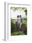 Full Length Side View of a Couple Kissing on Countryside Wall against Landscape-Nosnibor137-Framed Photographic Print