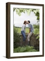 Full Length Side View of a Couple Kissing on Countryside Wall against Landscape-Nosnibor137-Framed Photographic Print