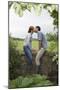 Full Length Side View of a Couple Kissing on Countryside Wall against Landscape-Nosnibor137-Mounted Photographic Print