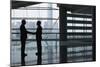 Full Length Side View of Businessmen Shaking Hands in Airport Terminal-Nosnibor137-Mounted Photographic Print