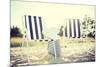 Furniture and Summer Holidays Concept - Two Beach Lounges with Beach Bag and White Hat on the Beach-dolgachov-Mounted Photographic Print