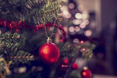 Closeup of Red Bauble Hanging from a Decorated Christmas Tree. Retro Filter Effect.-Gajus-Photographic Print