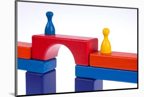 Gaming Pieces and Building Blocks Symbolising Breaking Down Barriers-Catharina Lux-Mounted Photographic Print