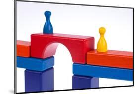 Gaming Pieces and Building Blocks Symbolising Breaking Down Barriers-Catharina Lux-Mounted Photographic Print