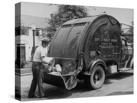 Garbage Man Emptying Trash into Back of Garbage Truck-Alfred Eisenstaedt-Stretched Canvas