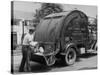 Garbage Man Emptying Trash into Back of Garbage Truck-Alfred Eisenstaedt-Stretched Canvas