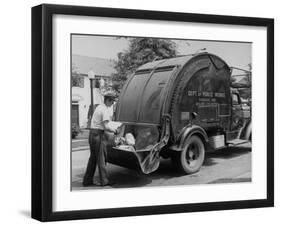 Garbage Man Emptying Trash into Back of Garbage Truck-Alfred Eisenstaedt-Framed Photographic Print