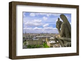 Gargoyle on the roof of Notre Dame cathedral looks out over Paris, France.-Tom Haseltine-Framed Photographic Print