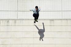 Male Tracer Free Runner Jumping Forward from High Rooftop over Cement Building Background, Young Tr-GaudiLab-Photographic Print