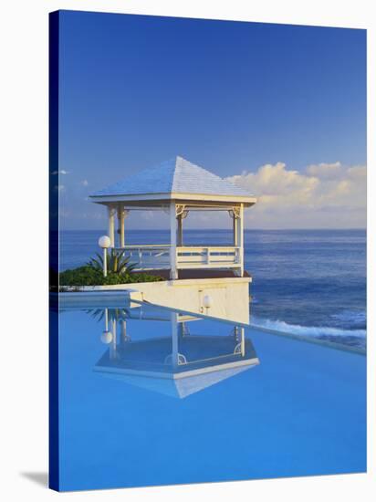 Gazebo Reflecting on Pool with Sea in Background, Long Island, Bahamas-Kent Foster-Stretched Canvas