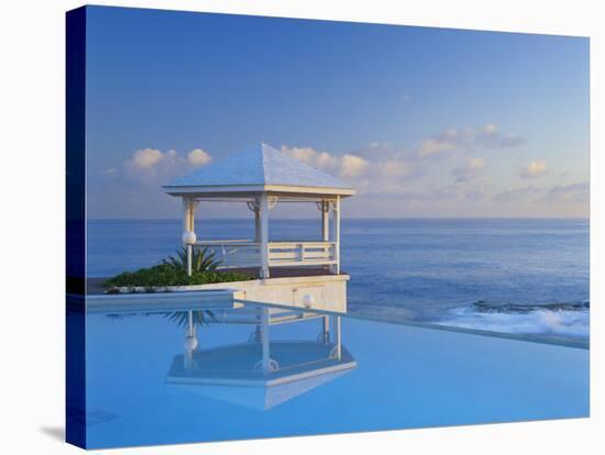 Gazebo Reflecting on Pool with Sea in Background, Long Island, Bahamas-Kent Foster-Stretched Canvas