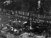 People and Horse Drawn Carts on Wall St, Where American Flags Fly from Buildings-George B^ Brainerd-Photographic Print