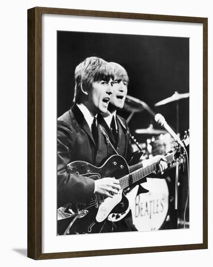 George Harrison (Left) and John Lennon of the Beatles-null-Framed Photo