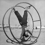 Girl Rolling in Large Wheel During Physical Education Class at North China Union University-George Lacks-Photographic Print