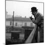 Georges Simenon Smoking the Pipe on a Bridge in Milan-null-Mounted Photographic Print