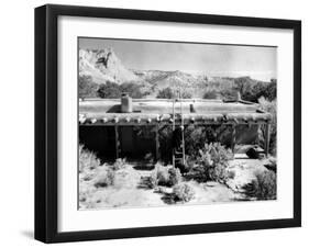 Georgia O'Keeffe Climbing a Ladder Outside Ghost Ranch, Her Desert Home-John Loengard-Framed Premium Photographic Print