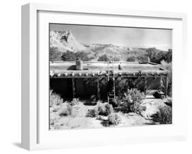 Georgia O'Keeffe Climbing a Ladder Outside Ghost Ranch, Her Desert Home-John Loengard-Framed Premium Photographic Print