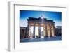 Germany, Berlin. Cyclists Passing under the Brandenburg Gate-Ken Scicluna-Framed Photographic Print