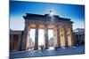 Germany, Berlin. Cyclists Passing under the Brandenburg Gate-Ken Scicluna-Mounted Photographic Print