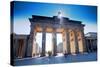 Germany, Berlin. Cyclists Passing under the Brandenburg Gate-Ken Scicluna-Stretched Canvas