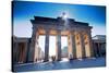 Germany, Berlin. Cyclists Passing under the Brandenburg Gate-Ken Scicluna-Stretched Canvas