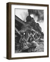 Gi Infantry Guards Keeping Warm by a Fire Next to an Army Engineer Built Railroad Bridge-Ralph Morse-Framed Photographic Print