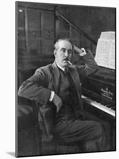 Giacomo Puccini Leans on the Pianoa Cigarette Dangling from the Side of His Mouth-G^ Magrini-Mounted Photographic Print