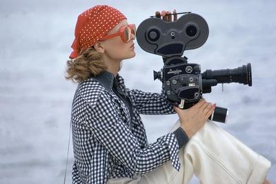Side View of Model Holding a Movie Camera, Filming in Paradise Island, Bahamas