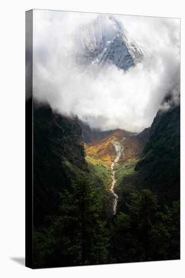 Giant mountain emerging through the clouds in the Himalayas, Nepal on the way to Everest Base Camp-David Chang-Stretched Canvas