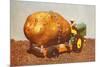 Giant Potato on Toy Tractor-null-Mounted Art Print