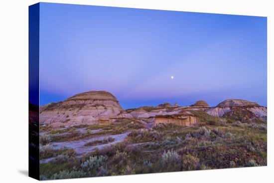 Gibbous Moon and Crepuscular Rays over Dinosaur Provincial Park, Canada-null-Stretched Canvas