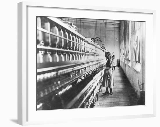 Girl at Spinning Machine-Lewis Wickes Hine-Framed Photographic Print