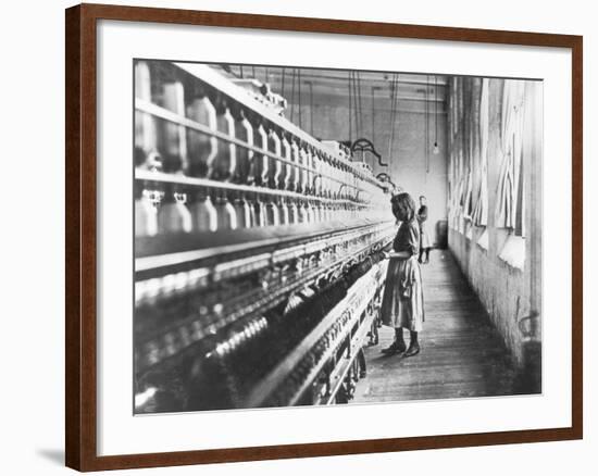 Girl at Spinning Machine-Lewis Wickes Hine-Framed Photographic Print