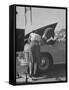 Girl Attendant Looking For Battery For Customer-Allan Grant-Framed Stretched Canvas