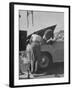 Girl Attendant Looking For Battery For Customer-Allan Grant-Framed Photographic Print