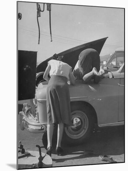 Girl Attendant Looking For Battery For Customer-Allan Grant-Mounted Photographic Print