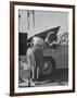 Girl Attendant Looking For Battery For Customer-Allan Grant-Framed Photographic Print