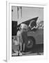 Girl Attendant Looking For Battery For Customer-Allan Grant-Framed Photographic Print