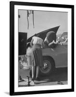 Girl Attendant Looking For Battery For Customer-Allan Grant-Framed Photographic Print