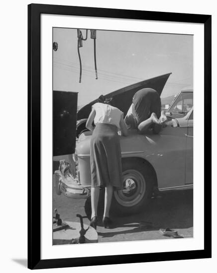 Girl Attendant Looking For Battery For Customer-Allan Grant-Framed Photographic Print