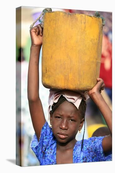 Girl carrying a heavy load, St. Louis, Senegal-Godong-Stretched Canvas