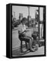 Girl Change Maker Knitting During Slow Moments at the Gilmore Self-Service Gas Station-Allan Grant-Framed Stretched Canvas