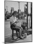 Girl Change Maker Knitting During Slow Moments at the Gilmore Self-Service Gas Station-Allan Grant-Mounted Photographic Print