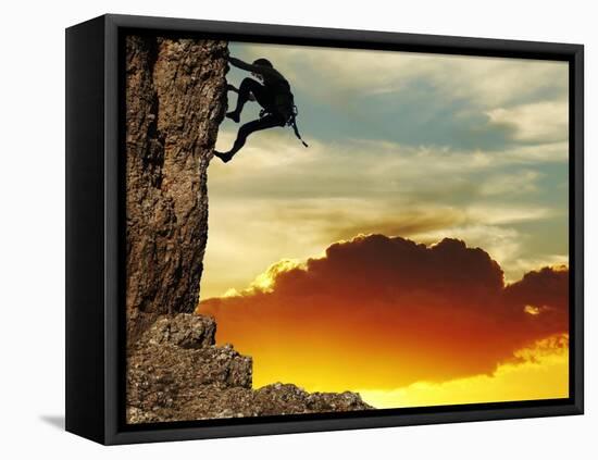 Girl Climbing On The Rock On Sunset Background-Andrushko Galyna-Framed Stretched Canvas