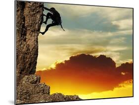 Girl Climbing On The Rock On Sunset Background-Andrushko Galyna-Mounted Art Print
