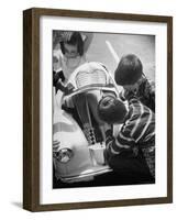 Girl Demurely Adjusting Her Hair While Willing Volunteers Repair Jammed Front Wheels of Her Car-Nina Leen-Framed Photographic Print