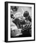 Girl Demurely Adjusting Her Hair While Willing Volunteers Repair Jammed Front Wheels of Her Car-Nina Leen-Framed Photographic Print