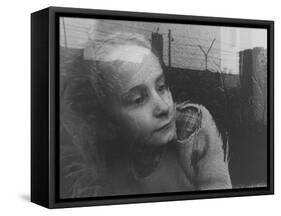 Girl Gazing Pensively Through Pane of Her Apartment Window, Grimly Reflects Image of Berlin Wall-Paul Schutzer-Framed Stretched Canvas