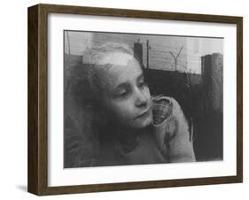 Girl Gazing Pensively Through Pane of Her Apartment Window, Grimly Reflects Image of Berlin Wall-Paul Schutzer-Framed Photographic Print