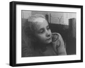 Girl Gazing Pensively Through Pane of Her Apartment Window, Grimly Reflects Image of Berlin Wall-Paul Schutzer-Framed Photographic Print